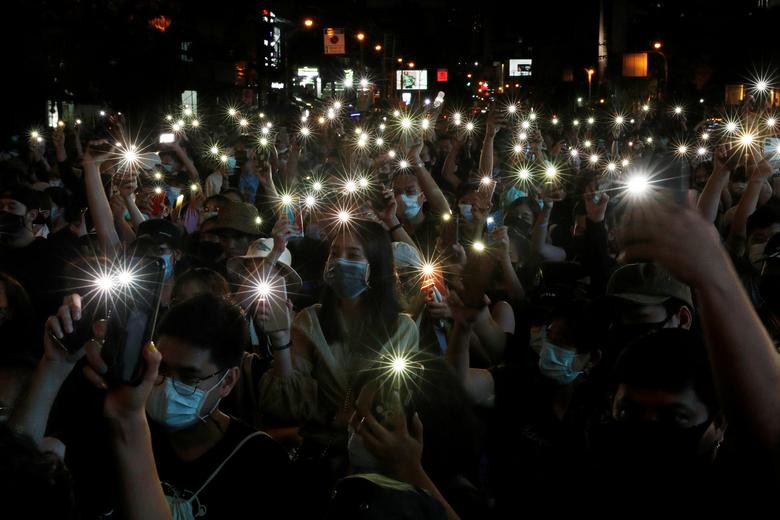Pro-democracy protesters shine their mobile phone lights during an anti-government protest, in Bangkok, Thailand October 18. REUTERS/Jorge Silva
